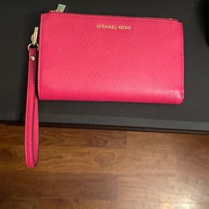 Michael kors wristlet.  Holds an I phone!